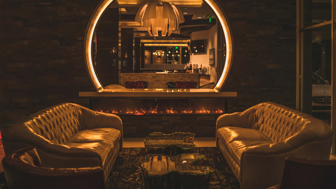 Two leather sofas facing each other in a dimly lit lounge
